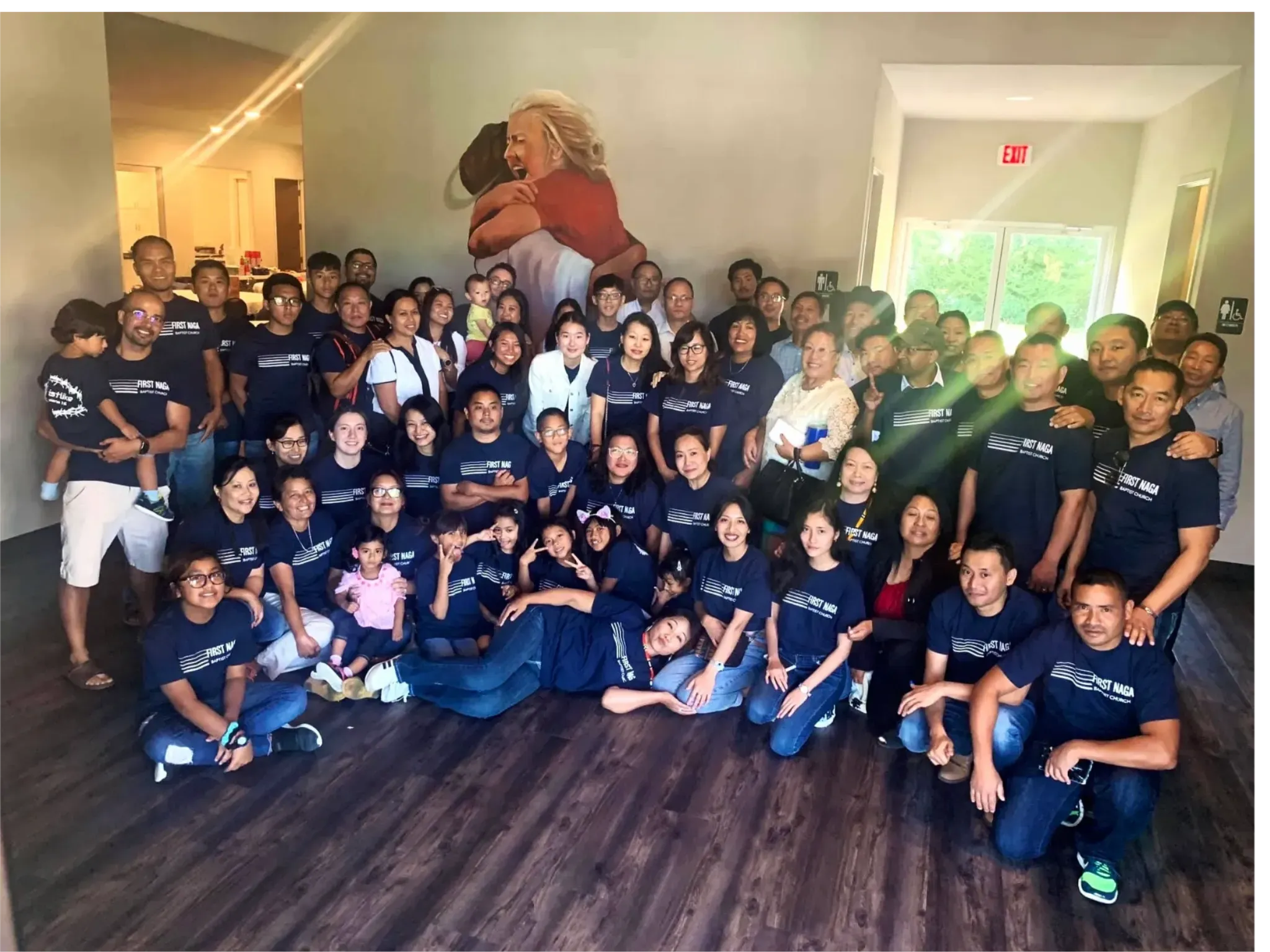 A large group of First Naga Baptist Church members wearing matching navy shirts